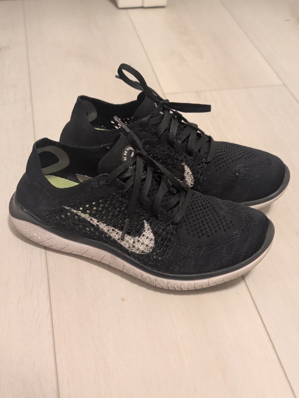Nike Women’s Black Flyknit Running Sneakers with White Swoosh